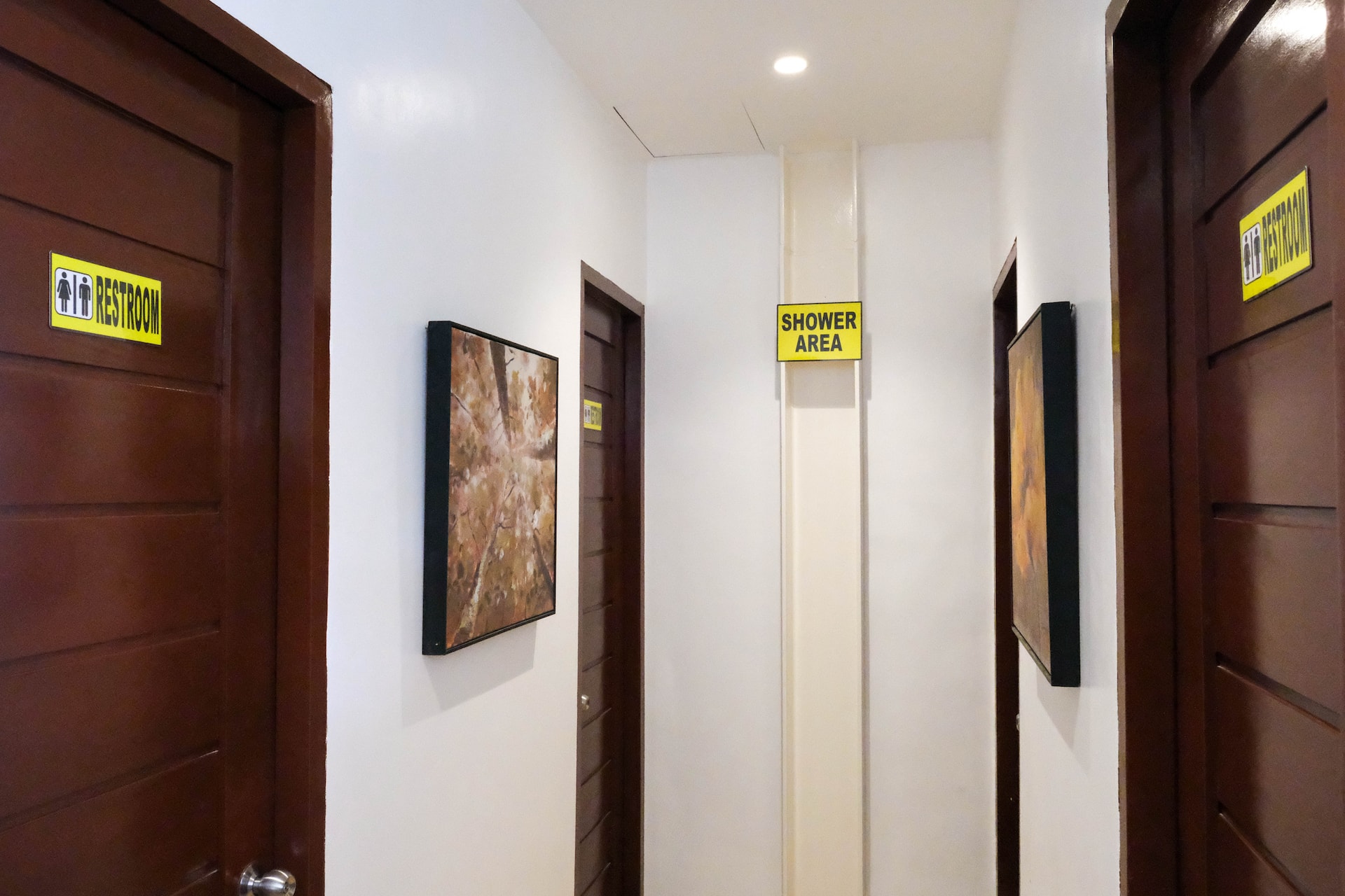 Guest Restroom & Shower Corridor with Dedicated Stalls & Signage