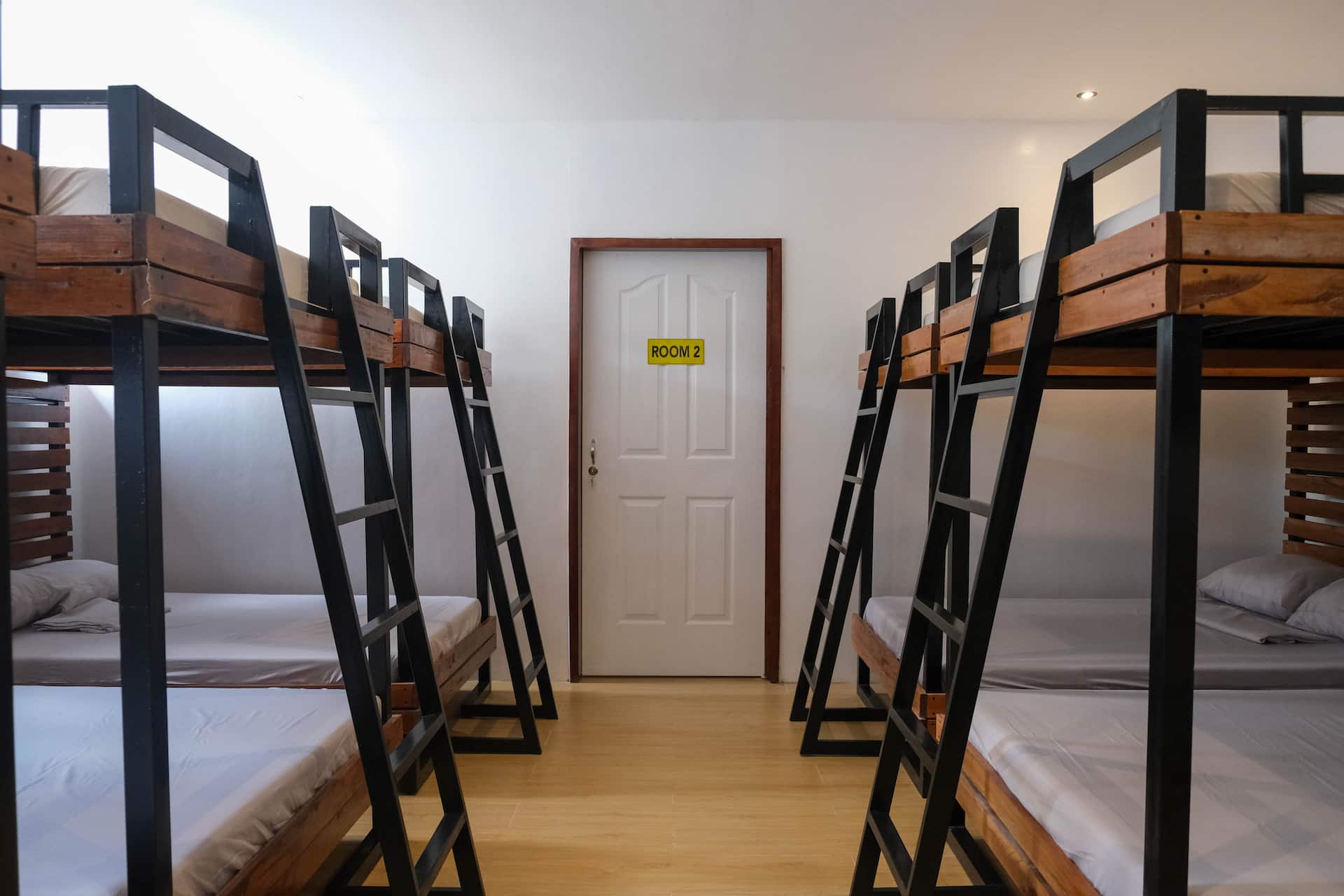 Bunk Room 2 Doorway Flanked by 4 Built-In Double-Deck Bunk Pods