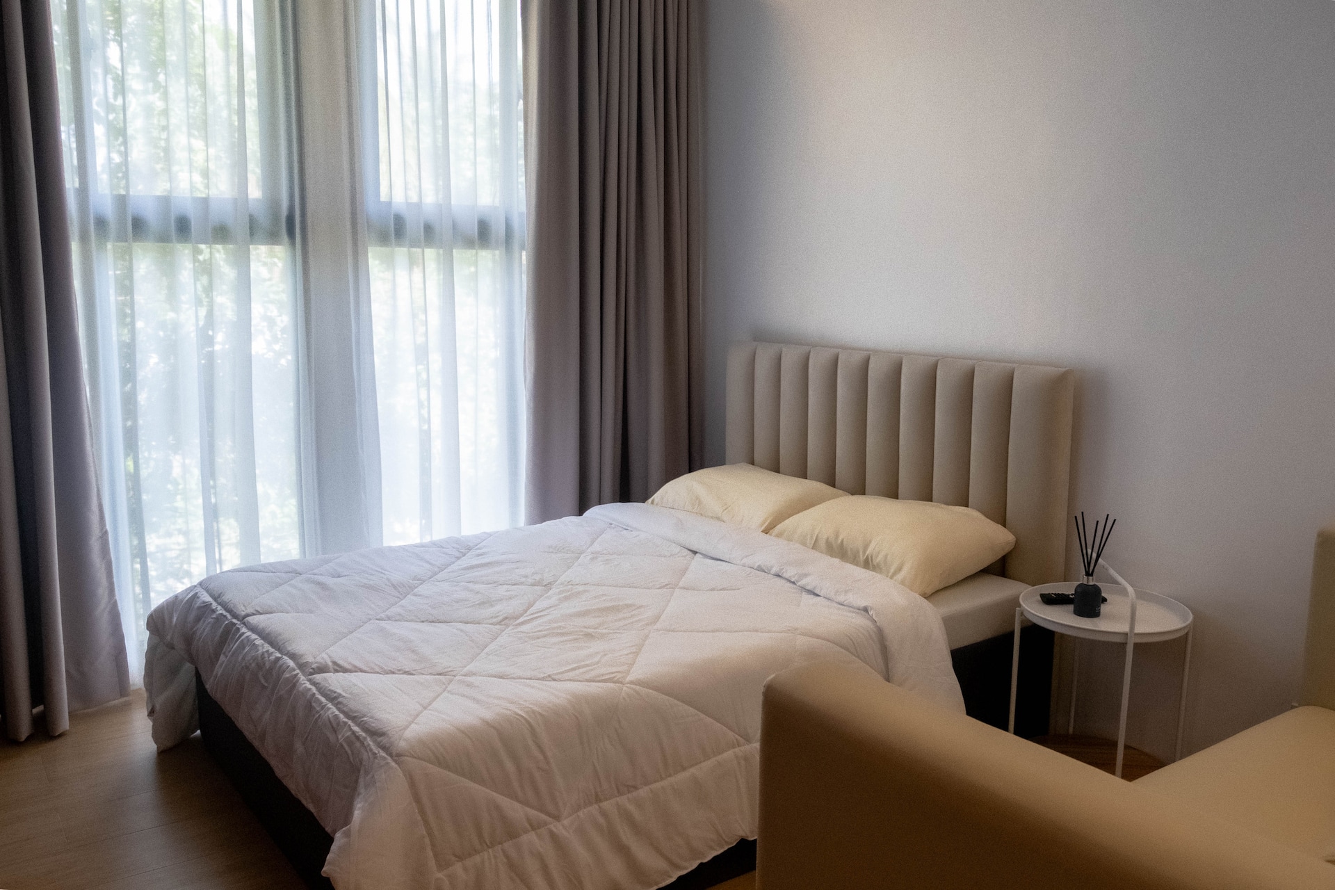 VIP Master Suite Queen Bed Perspective with Sunlit Window & Lounge Chair
