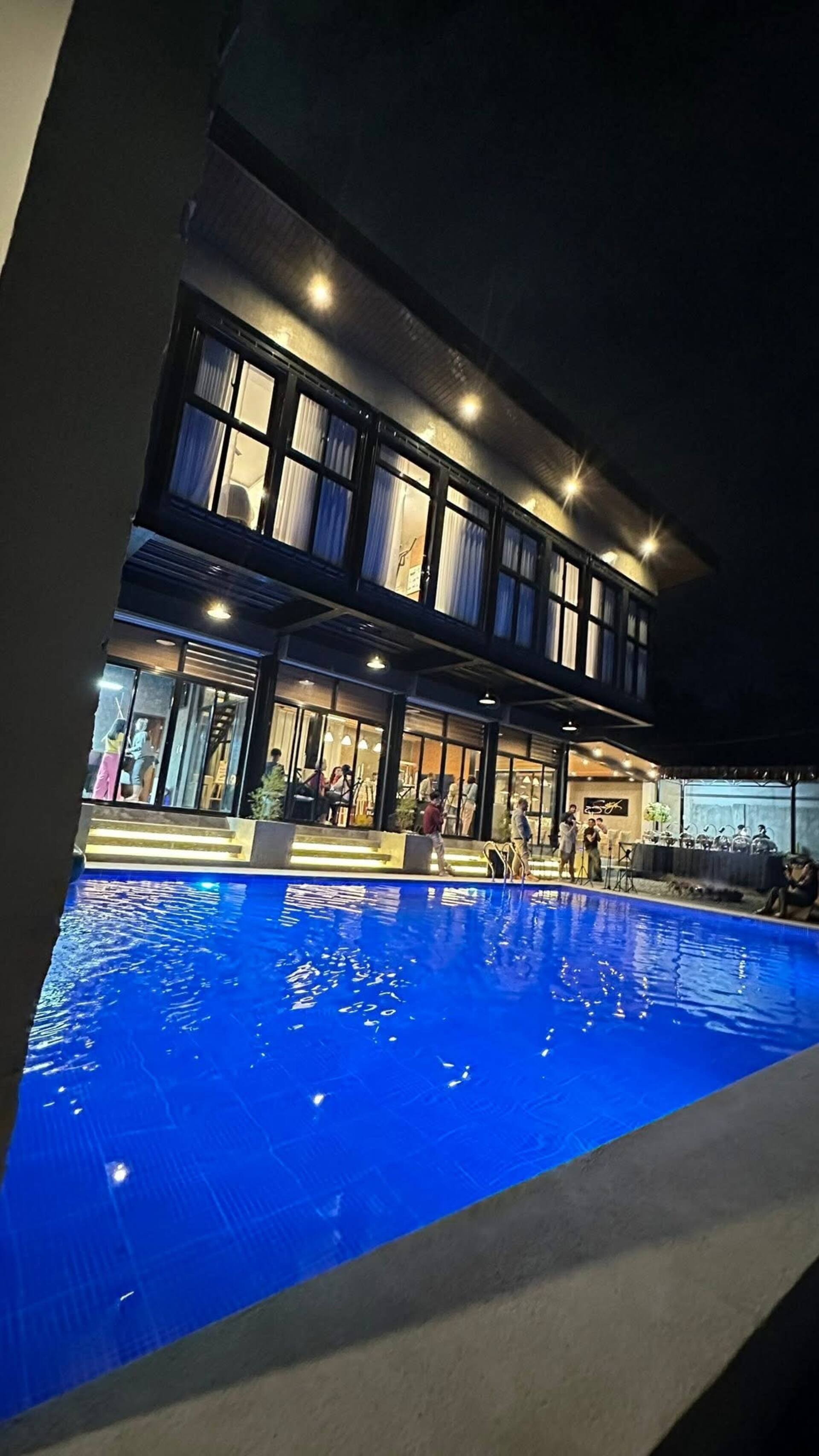 Evening Poolside Gathering with Blue LED Ambient Lighting
