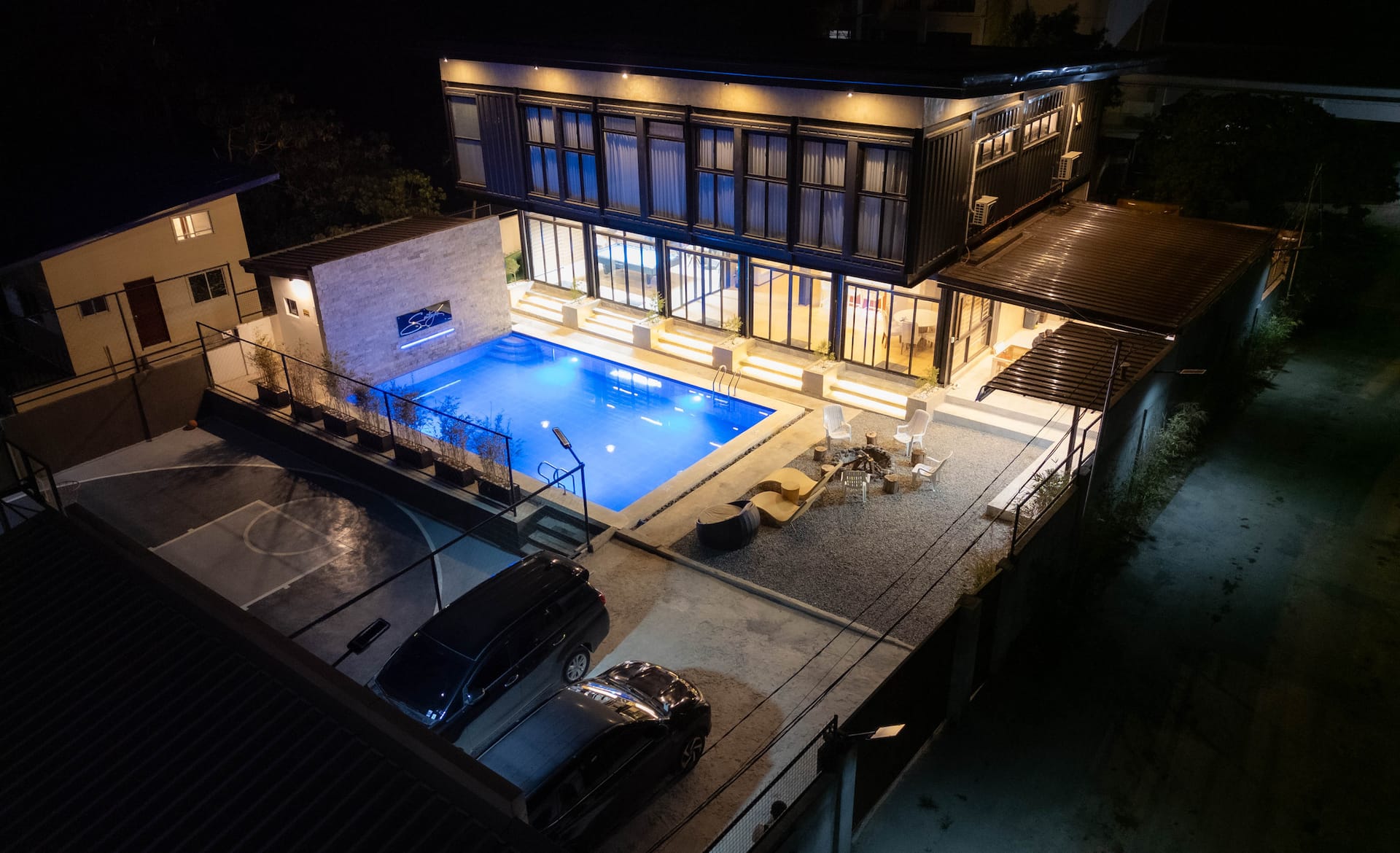Night Drone Aerial Panorama of Compound & Illuminated Pool
