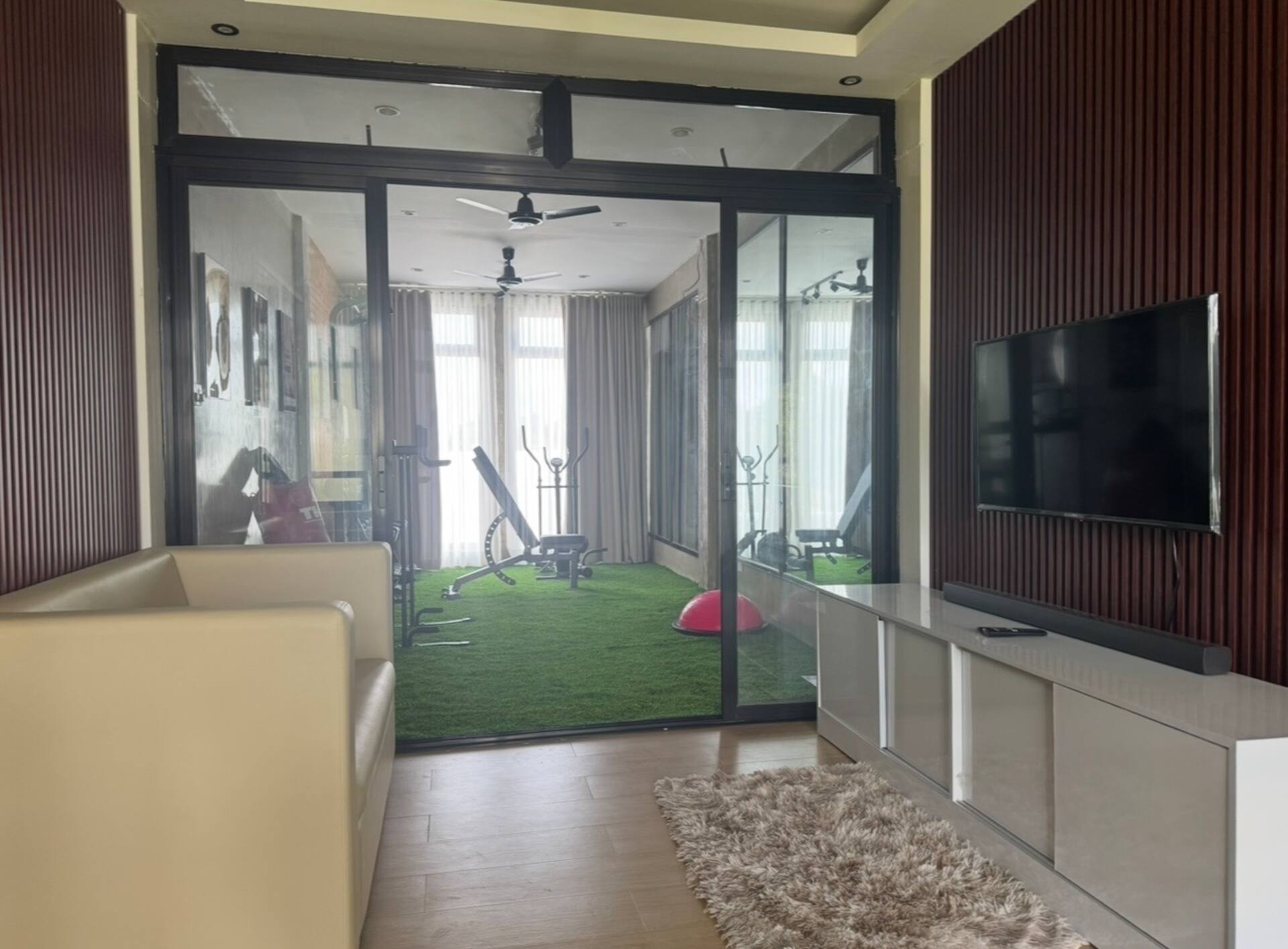 Private Lounge View into Glass-Enclosed Turf Gym
