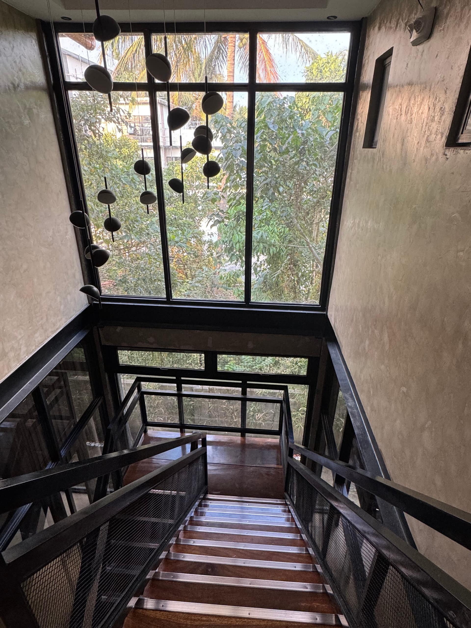 Steel & Hardwood Staircase with 2-Storey Forest View Windows