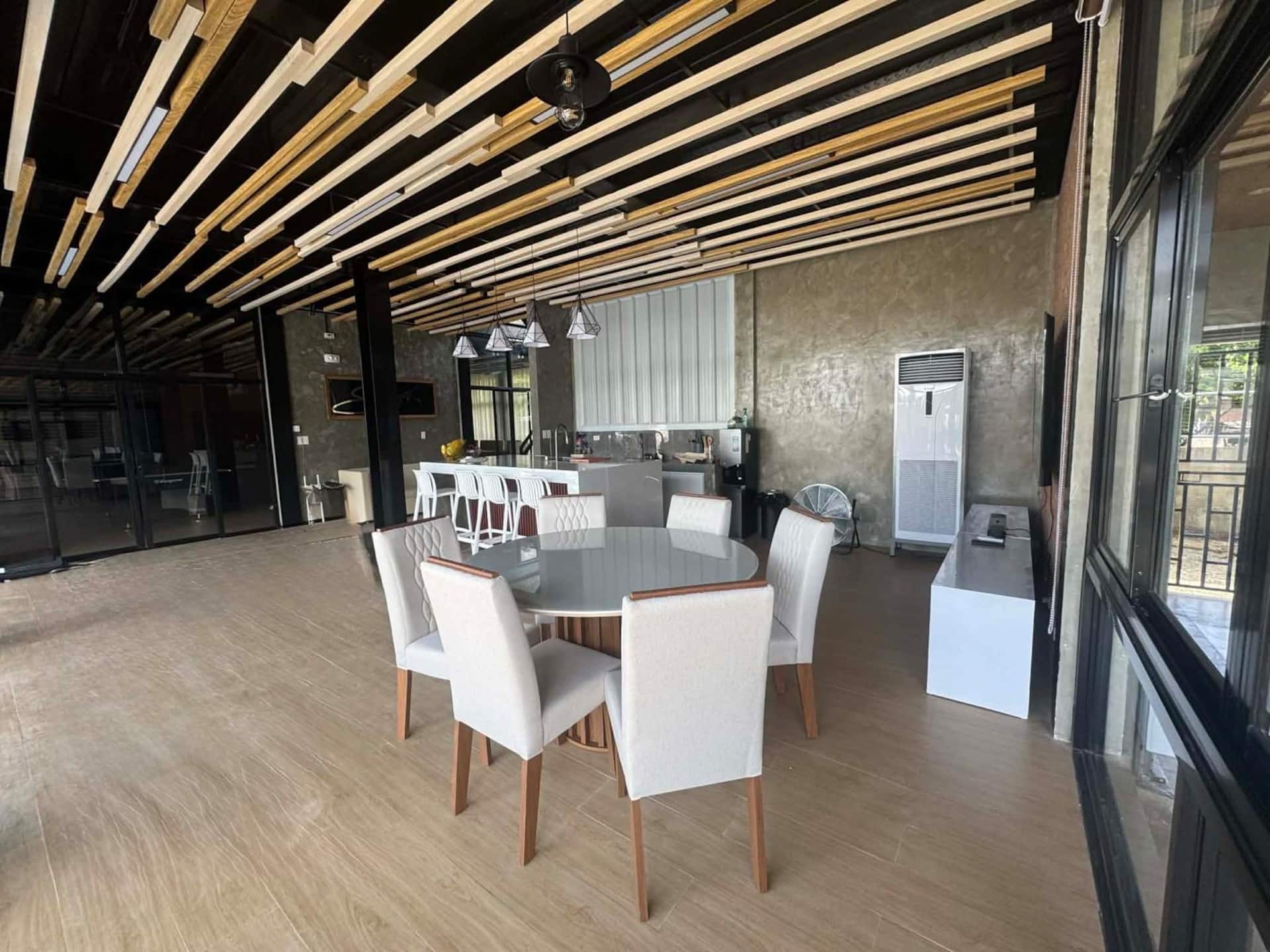 Indoor Dining Area with Round Glass Table & Commercial AC