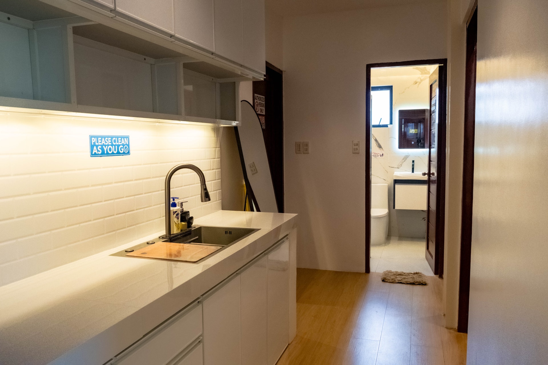 Prep Kitchen Counter with Subway Tiles & Hallway to Restroom