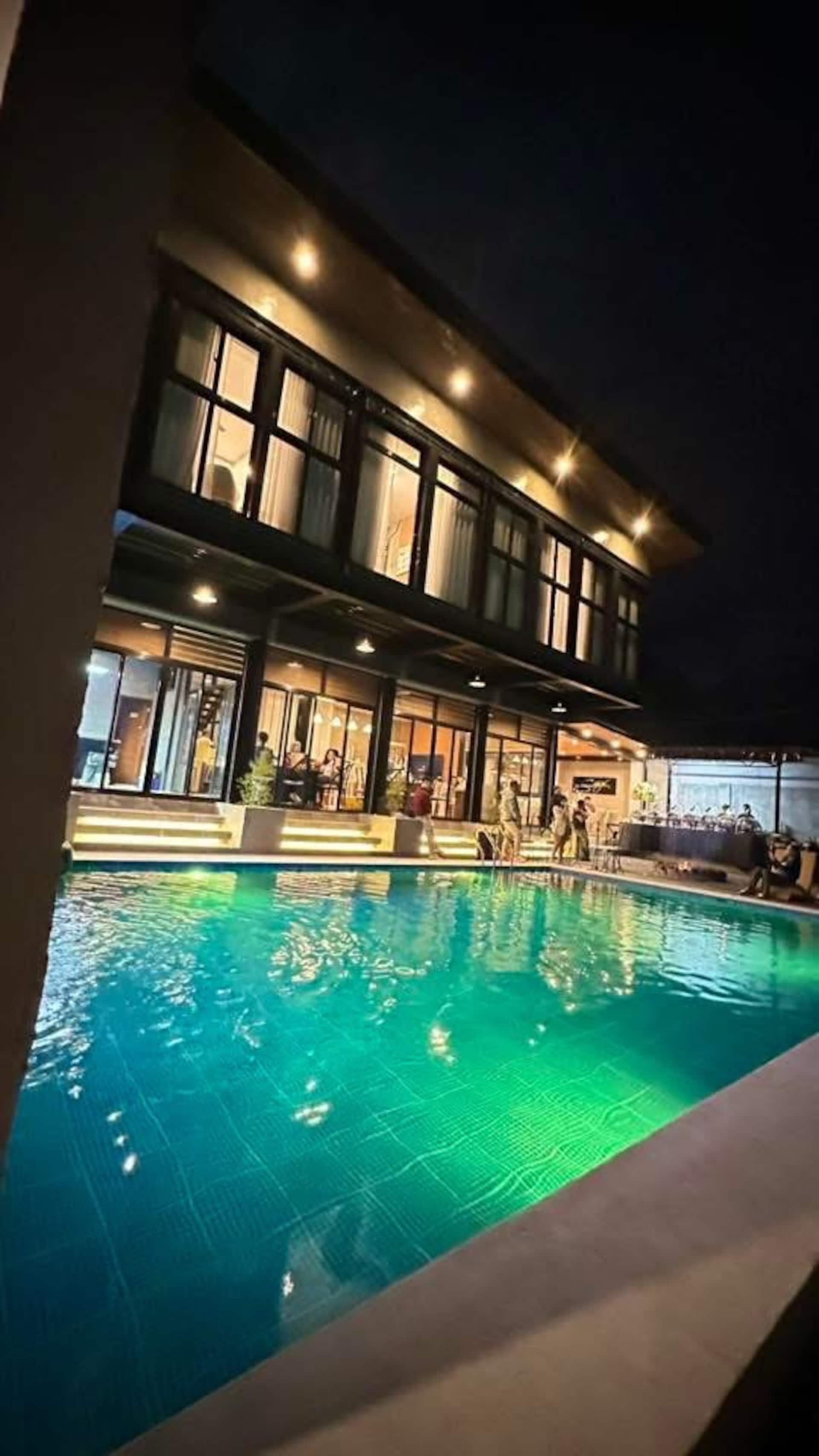 Evening Pool Gathering with Green LED Ambient Lighting